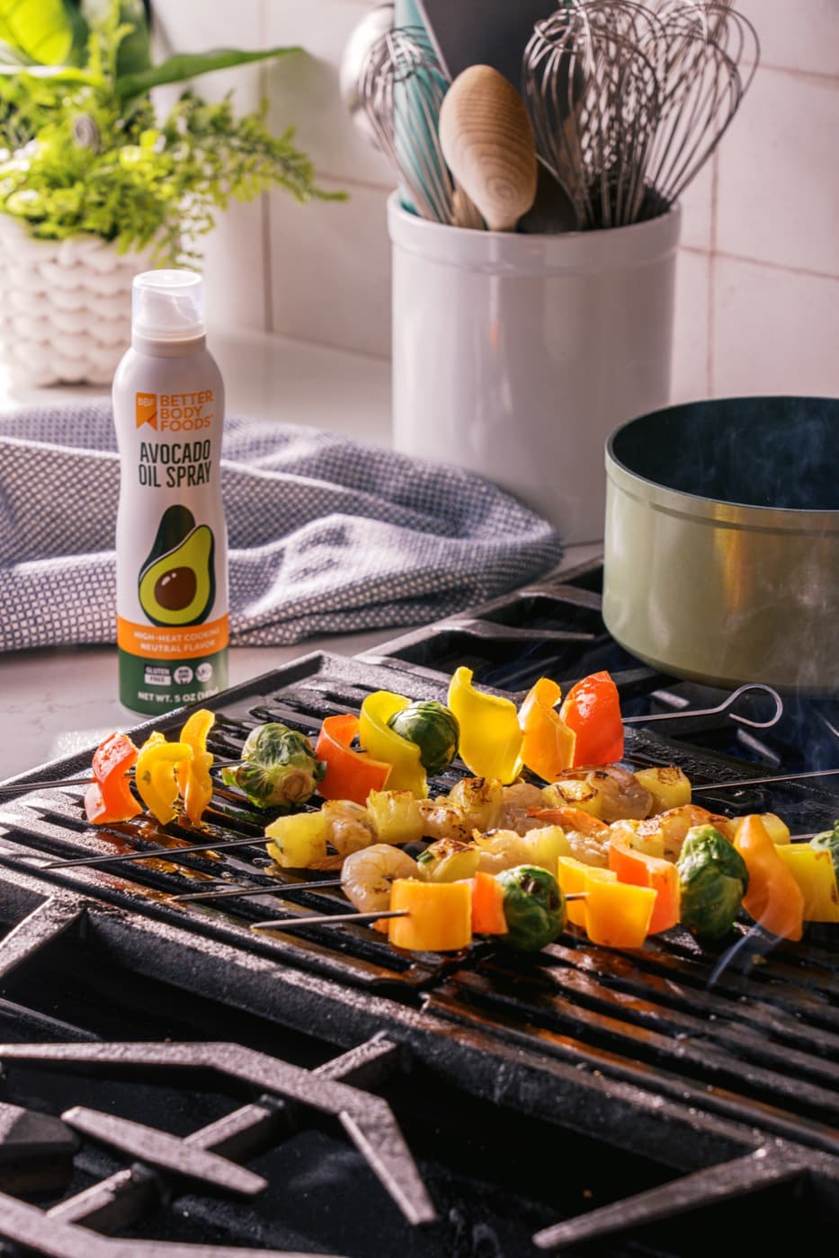 Vegetable and shrimp skewers cooking on a grill.