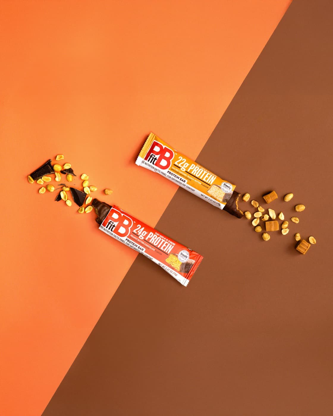 PBfit protein bars and peanut pieces on an orange background.