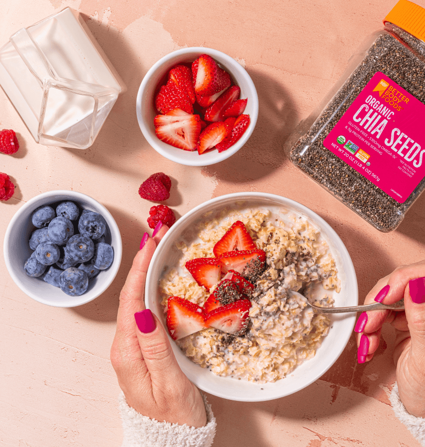 Chia seeds with oatmeal, strawberries, blueberries, raspberries, and milk.