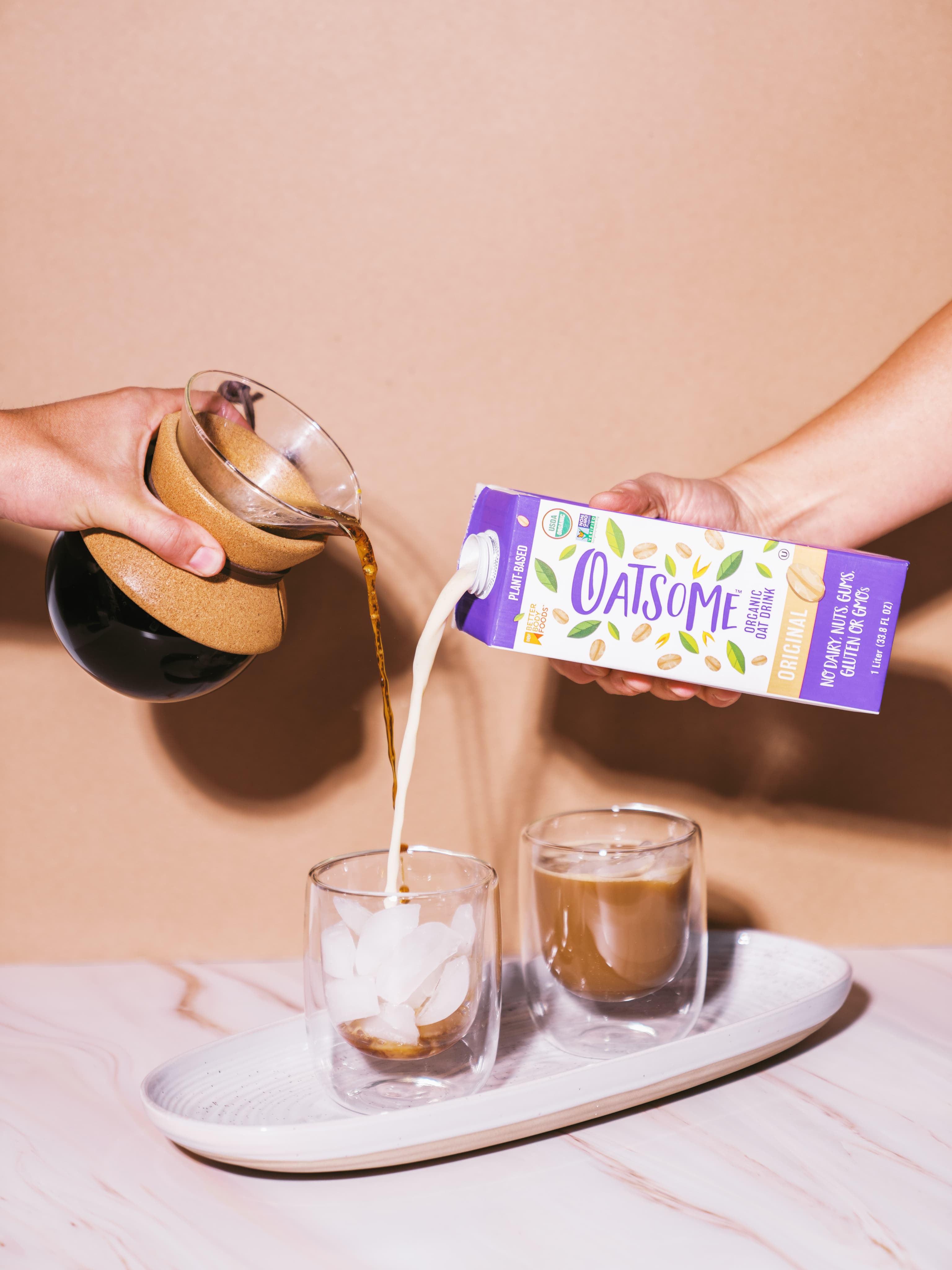 Oatsome oat milk poured into a glass.