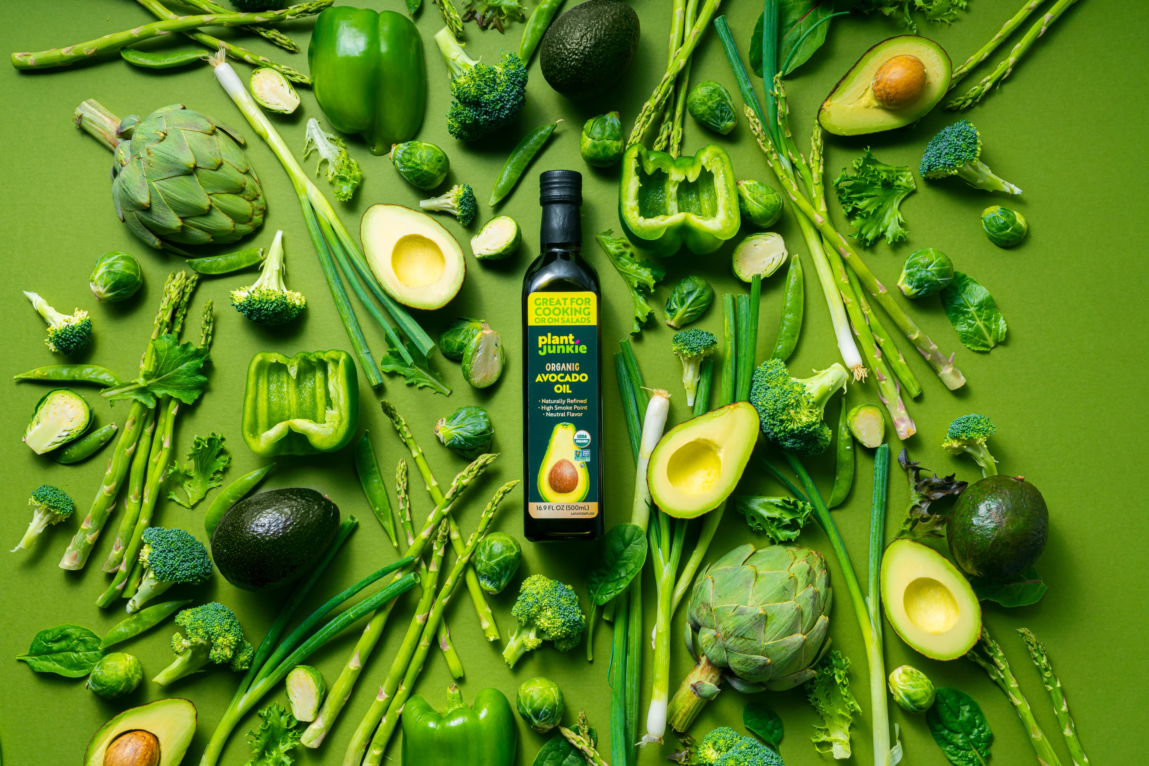 Plant Junkie avocado oil bottles with avocados.